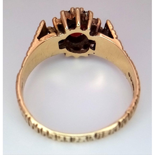 1190 - A 9K Yellow Gold Garnet and Diamond Halo Patterned Band Ring, 0.12ct diamond weight, 0.55ct garnet w... 