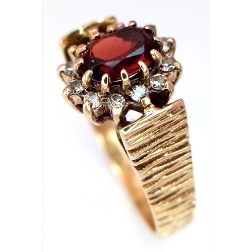 1190 - A 9K Yellow Gold Garnet and Diamond Halo Patterned Band Ring, 0.12ct diamond weight, 0.55ct garnet w... 