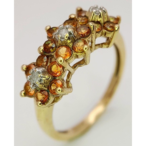 1516 - A 9K Yellow Gold Diamond and Orange Stone Set Ring, in the Floral Design ; 0.06ct diamond, 2.1g tota... 