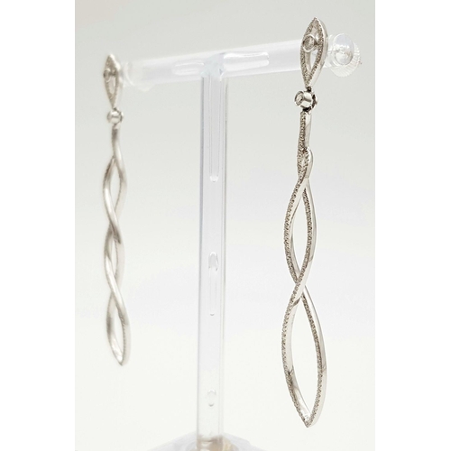 458 - A Pair of 18K White Gold Diamond Drop Earrings. Two wonderful 7cm diamond spiral drops - 1.4ctw appr... 