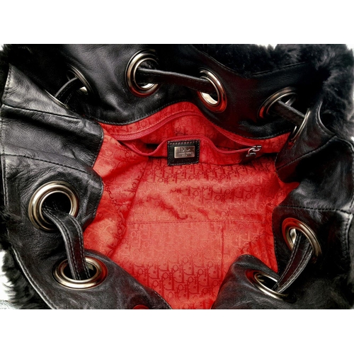 1005 - A Christian Dior Faux Fur Shoulder Bag with Hanging Tassels. Silver tone hardware. Red textile inter... 