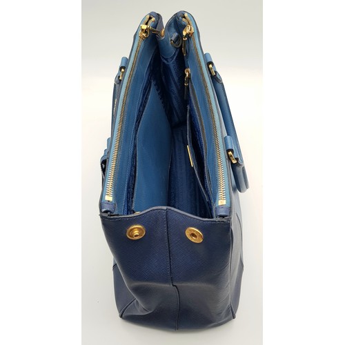 717 - A Prada Blue Saffiano Leather Double Handle Bag. Two-tone blue saffiano leather exterior with gold-t... 