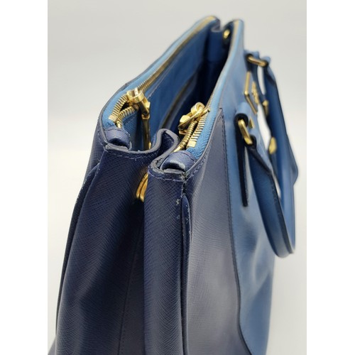 717 - A Prada Blue Saffiano Leather Double Handle Bag. Two-tone blue saffiano leather exterior with gold-t... 