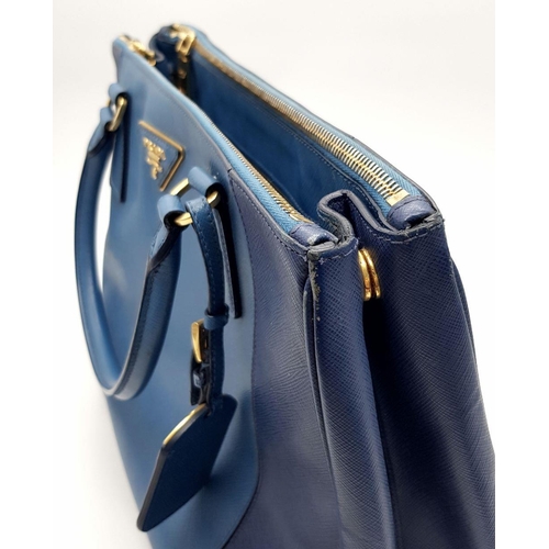 717 - A Prada Blue Saffiano Leather Double Handle Bag. Two-tone blue saffiano leather exterior with gold-t... 