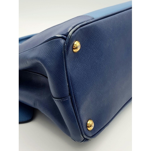 717 - A Prada Blue Saffiano Leather Double Handle Bag. Two-tone blue saffiano leather exterior with gold-t... 