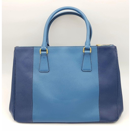 717 - A Prada Blue Saffiano Leather Double Handle Bag. Two-tone blue saffiano leather exterior with gold-t... 