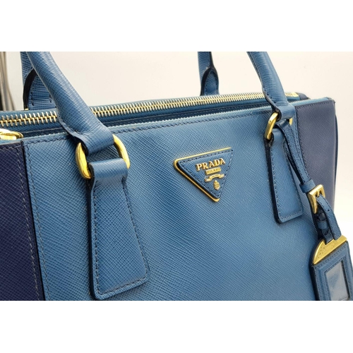 717 - A Prada Blue Saffiano Leather Double Handle Bag. Two-tone blue saffiano leather exterior with gold-t... 