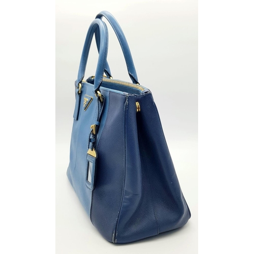 717 - A Prada Blue Saffiano Leather Double Handle Bag. Two-tone blue saffiano leather exterior with gold-t... 