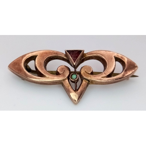 1003 - An Antique Rose 9K Gold, Garnet and Turquoise Brooch. Pin has been replaced. 3.5cm. 1.85g total weig... 