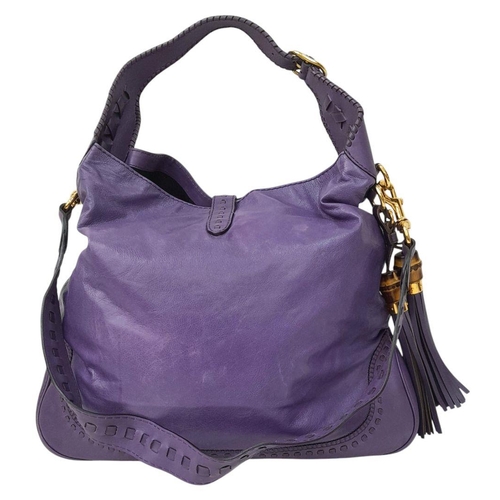 101 - A Gucci Purple Leather Jackie Tote Bag. Decorated with bamboo tassels and gold tone hardware. Remova... 