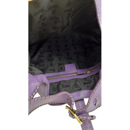 101 - A Gucci Purple Leather Jackie Tote Bag. Decorated with bamboo tassels and gold tone hardware. Remova... 