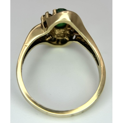 102 - A 14K YELLOW GOLD DIAMOND AND EMERALD FANCY RING. 0.40CT. SLIGHT DAMAGE ON THE EMERALD - NOT VISIBLE... 