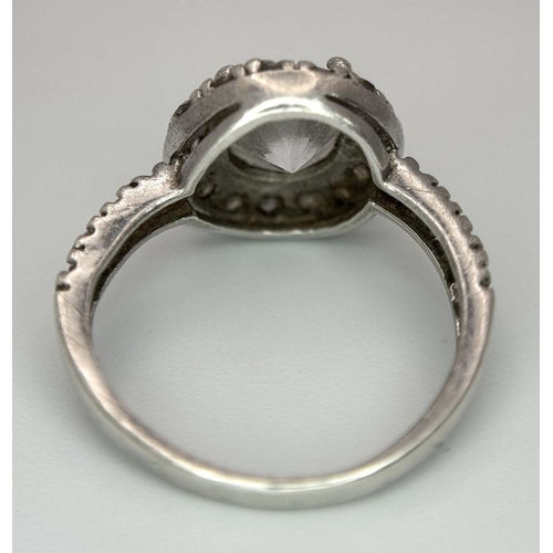 1077 - A STERLING SILVER HALO STONE SET RING. 3G. SIZE L. 8780.