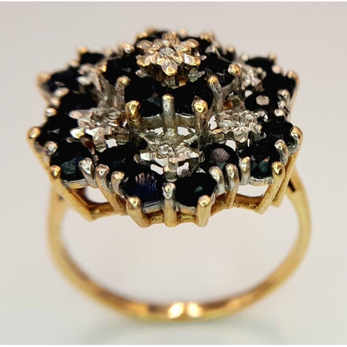 193 - AN ARTISTICALLY SET, 9K YELLOW GOLD DIAMOND AND SAPPHIRE LARGE CLUSTER RING. 5G. SIZE U. SC5050