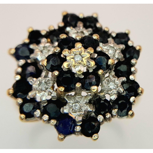 193 - AN ARTISTICALLY SET, 9K YELLOW GOLD DIAMOND AND SAPPHIRE LARGE CLUSTER RING. 5G. SIZE U. SC5050