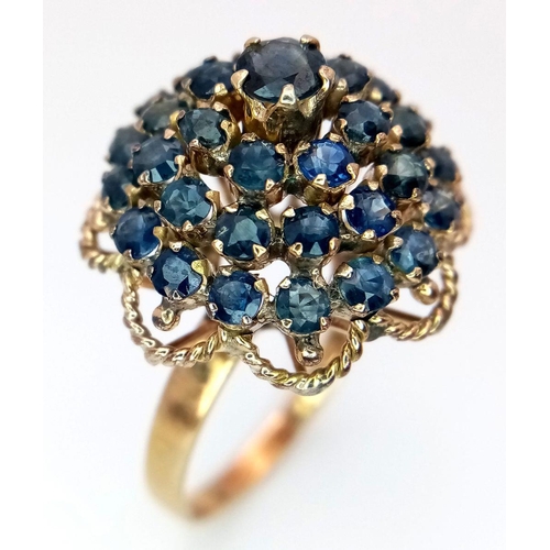 221 - A 9K YELLOW GOLD SAPPHIRE SET CLUSTER RING. 4.6G. SIZE S. SC5004.