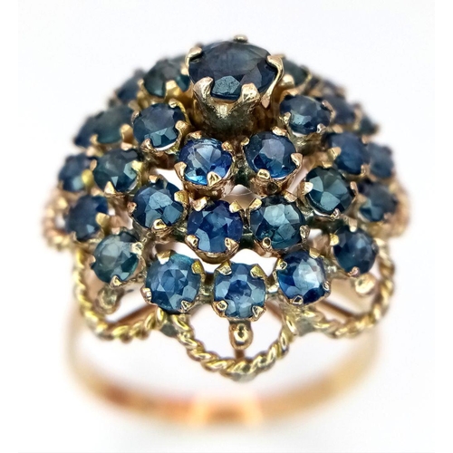 221 - A 9K YELLOW GOLD SAPPHIRE SET CLUSTER RING. 4.6G. SIZE S. SC5004.