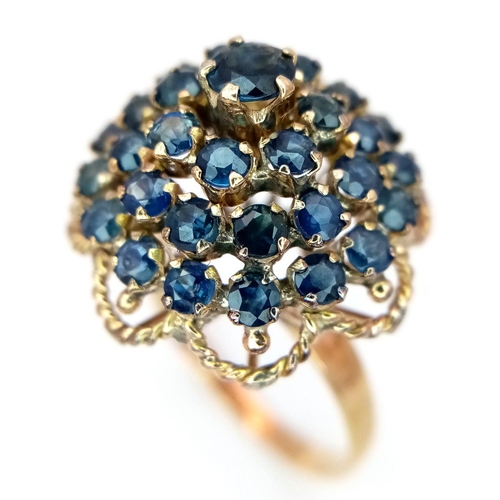 221 - A 9K YELLOW GOLD SAPPHIRE SET CLUSTER RING. 4.6G. SIZE S. SC5004.