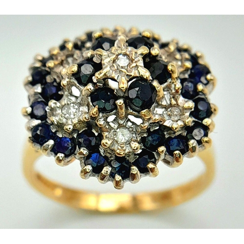 228 - A WONDERFUL 9K YELLOW GOLD DIAMOND AND SAPPHIRE CLUSTER RING. HEAD-TURNING FLORAL FORM DESIGN. 5.2G.... 