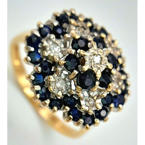 228 - A WONDERFUL 9K YELLOW GOLD DIAMOND AND SAPPHIRE CLUSTER RING. HEAD-TURNING FLORAL FORM DESIGN. 5.2G.... 