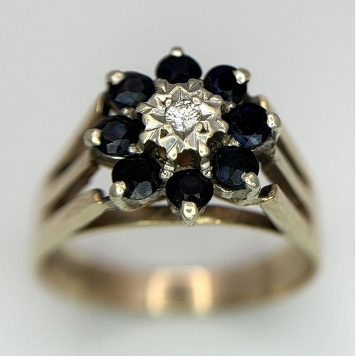 251 - A 9K YELLOW GOLD VINTAGE DIAMOND AND SAPPHIRE FLORAL FORM RING. RAISED SETTING. 3.9G. SIZE P. SC5032