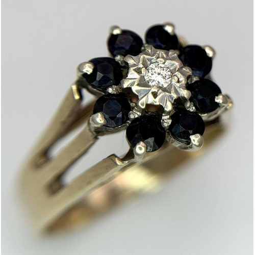 251 - A 9K YELLOW GOLD VINTAGE DIAMOND AND SAPPHIRE FLORAL FORM RING. RAISED SETTING. 3.9G. SIZE P. SC5032