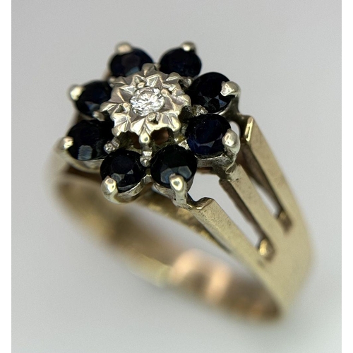 251 - A 9K YELLOW GOLD VINTAGE DIAMOND AND SAPPHIRE FLORAL FORM RING. RAISED SETTING. 3.9G. SIZE P. SC5032