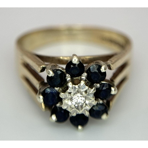 251 - A 9K YELLOW GOLD VINTAGE DIAMOND AND SAPPHIRE FLORAL FORM RING. RAISED SETTING. 3.9G. SIZE P. SC5032