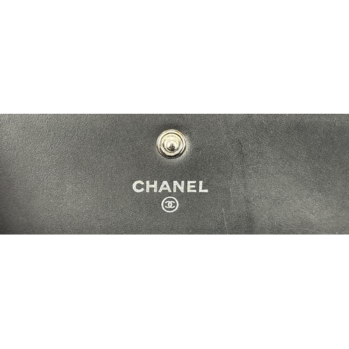 264 - A Chanel Quilted Patent Leather Black Purse/Wallet. Double CC exterior monogram. Leather and textile... 