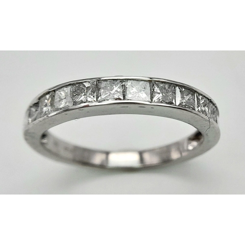 272 - A 9K WHITE GOLD DIAMOND SET HALF ETERNITY RING. PRINCESS CUTS. APPROX 1CTW. 2.4G. SIZE L. SC5046