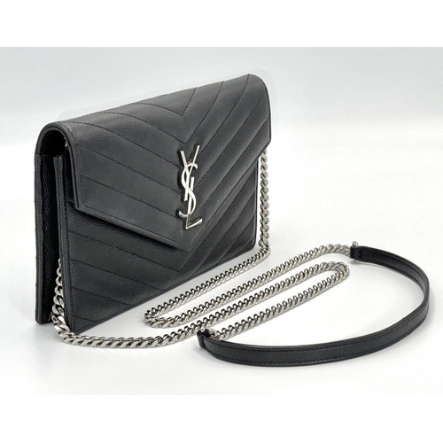 32 - A Sophisticated Yves Saint Laurent Crossbody Bag. Black leather quilted chevron exterior design. Bla... 