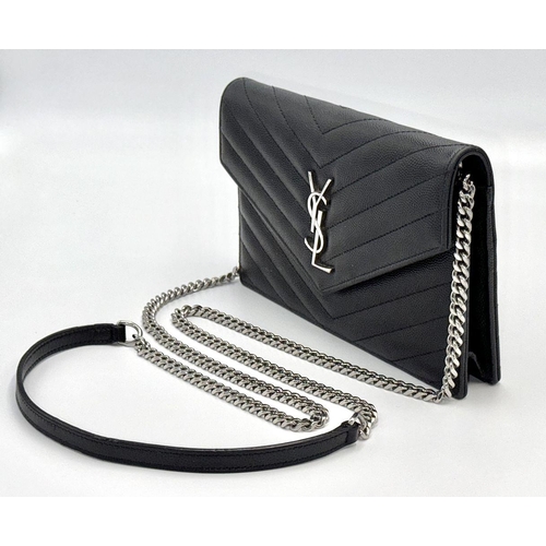 32 - A Sophisticated Yves Saint Laurent Crossbody Bag. Black leather quilted chevron exterior design. Bla... 