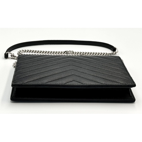 32 - A Sophisticated Yves Saint Laurent Crossbody Bag. Black leather quilted chevron exterior design. Bla... 