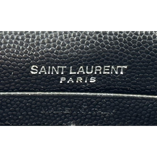 32 - A Sophisticated Yves Saint Laurent Crossbody Bag. Black leather quilted chevron exterior design. Bla... 