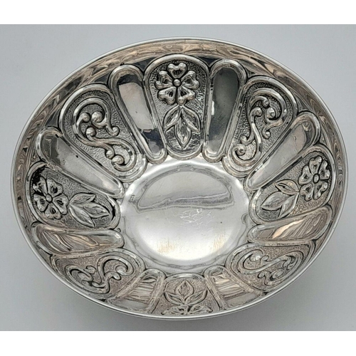 366 - A Vintage 925 Sterling Silver Chased Decorative Dish. On three pedestal feet. 13cm diameter. 72g