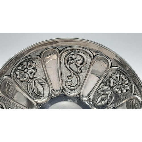 366 - A Vintage 925 Sterling Silver Chased Decorative Dish. On three pedestal feet. 13cm diameter. 72g