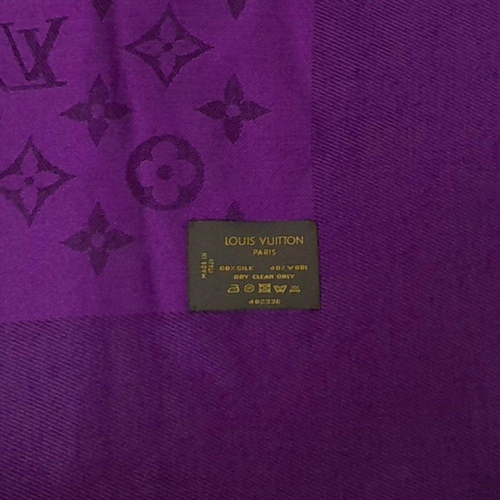 371 - A Louis Vuitton Purple Silk Scarf. LV monogram decoration. 
145cm x 75cm. Silk and wool mix. Italian... 