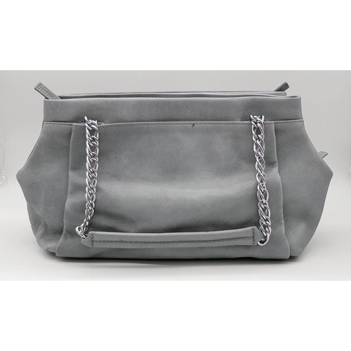 39 - A Chanel Grey Leather Shoulder Bag. Classic Double C exterior logo with silver tone and leather hand... 