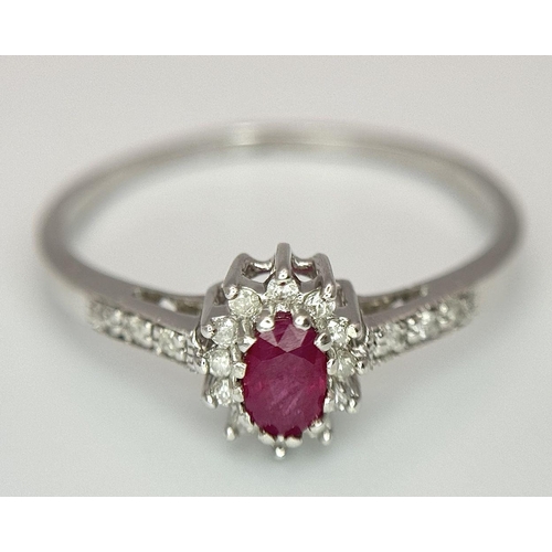 432 - A 9K WHITE GOLD DIAMOND AND RUBY RING. 2G. SIZE T. SC5034