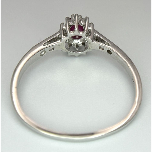 432 - A 9K WHITE GOLD DIAMOND AND RUBY RING. 2G. SIZE T. SC5034