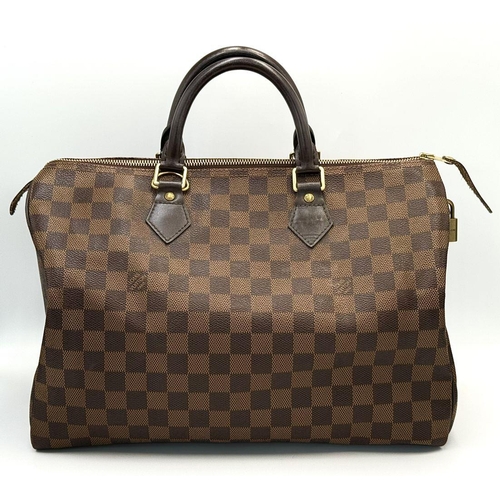 88 - A Louis Vuitton Speedy Damier Bag. Brown checked LV coated canvas exterior. Gold tone furniture. Red... 