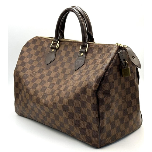 88 - A Louis Vuitton Speedy Damier Bag. Brown checked LV coated canvas exterior. Gold tone furniture. Red... 