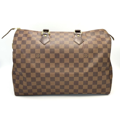 88 - A Louis Vuitton Speedy Damier Bag. Brown checked LV coated canvas exterior. Gold tone furniture. Red... 