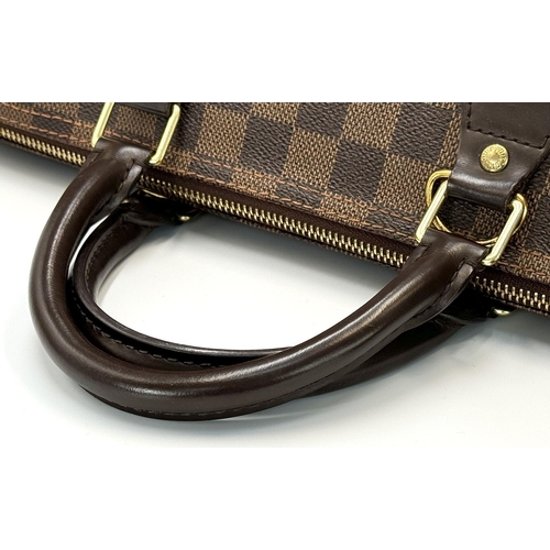 88 - A Louis Vuitton Speedy Damier Bag. Brown checked LV coated canvas exterior. Gold tone furniture. Red... 