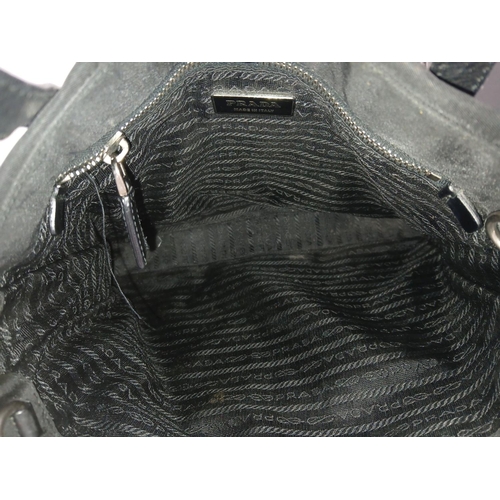 1174 - A Prada Black Textile Hand/Shoulder bag. Black leather trim and handles. Removable shoulder strap. T... 