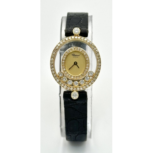 1186 - A Chopard Happy Diamond Ladies Watch. Blue leather strap. 18K Gold case with six floating diamonds a... 