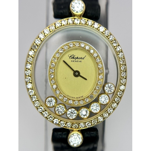 1186 - A Chopard Happy Diamond Ladies Watch. Blue leather strap. 18K Gold case with six floating diamonds a... 