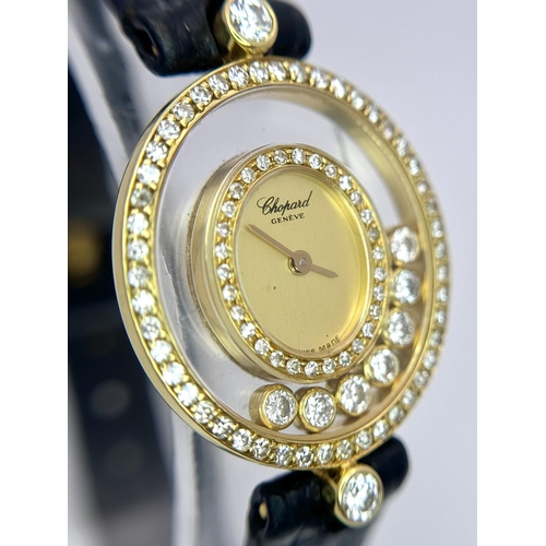 1186 - A Chopard Happy Diamond Ladies Watch. Blue leather strap. 18K Gold case with six floating diamonds a... 