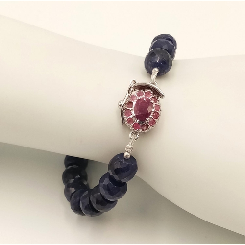 1475 - A 210ctw Blue Sapphire Gemstone Bracelet with Ruby Clasp. Set in 925 Silver. 16cm length.