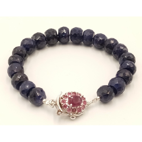 1475 - A 210ctw Blue Sapphire Gemstone Bracelet with Ruby Clasp. Set in 925 Silver. 16cm length.